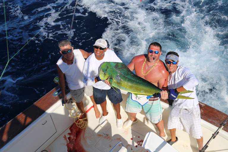 The fishing charters team holding a Mahi Mahi