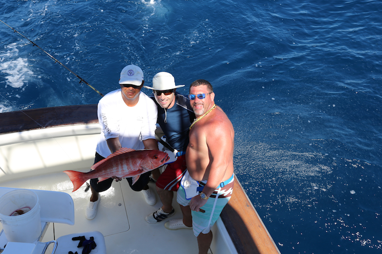 Danny and his team with a red sea bass