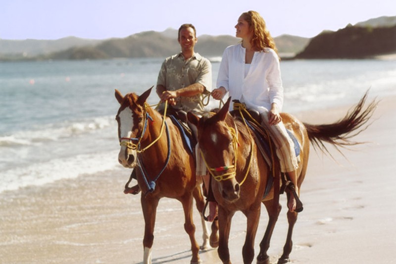 Living in Costa Rica includes riding horses on the beach 89