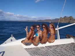 Four girls sitting on the Marlin del Rey catamaran in Costa Rica